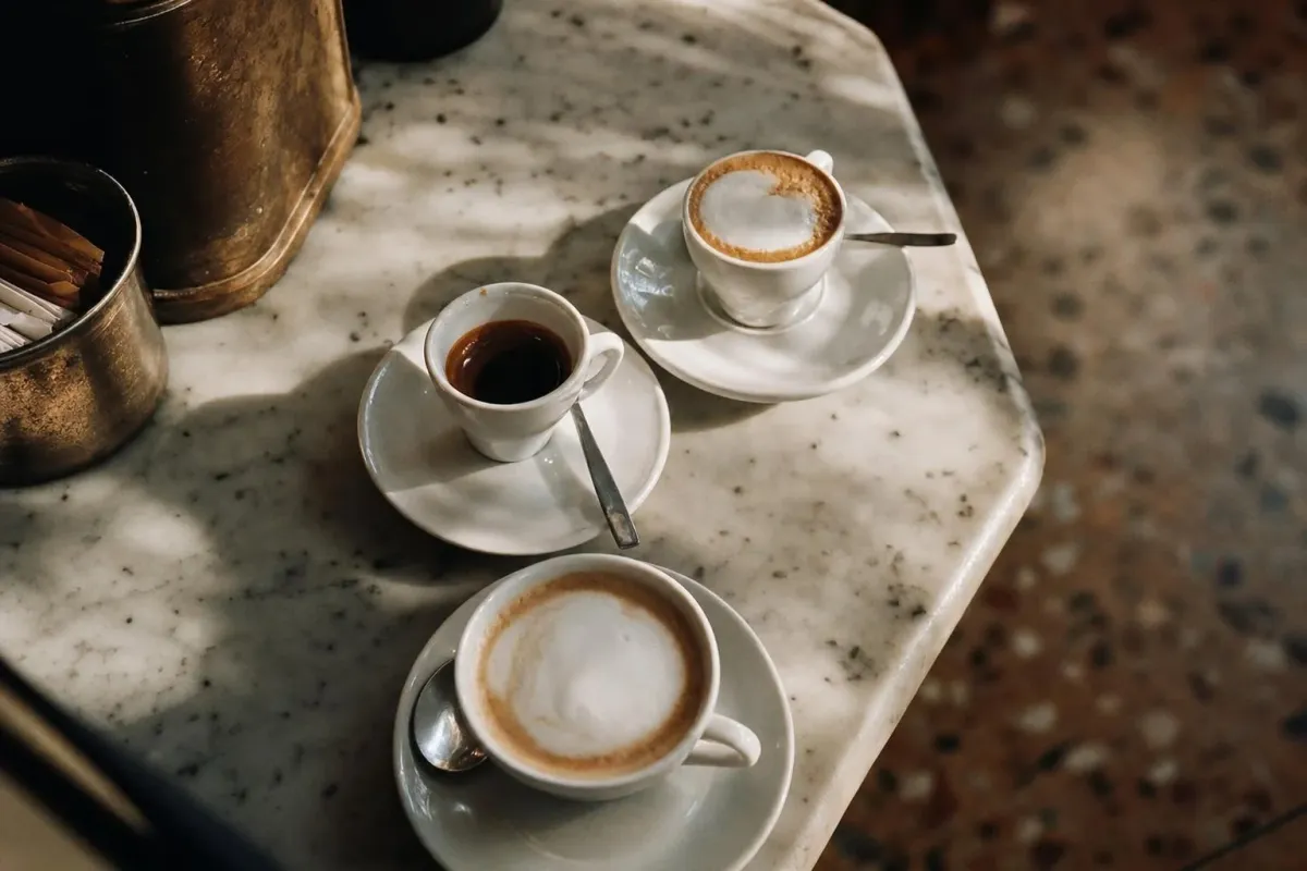 Several Italian coffees, espresso, macchiato, and cappuccino, seen from above on a bar counter