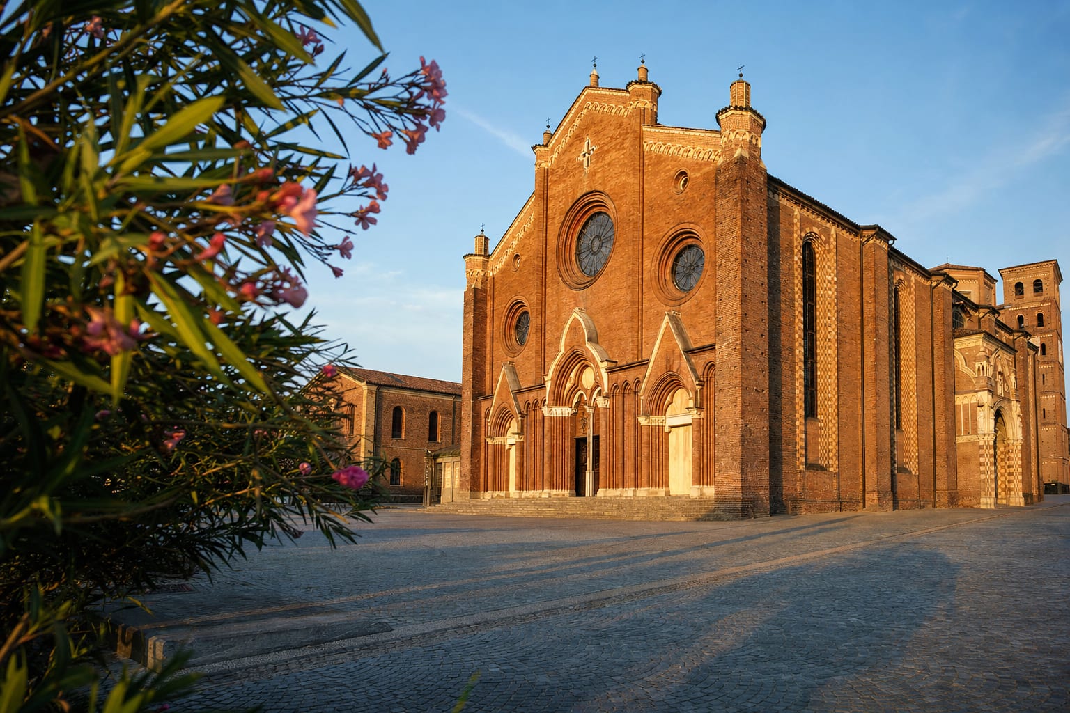 The brick Gothic bulk of Asti Cathedral at golden hour
