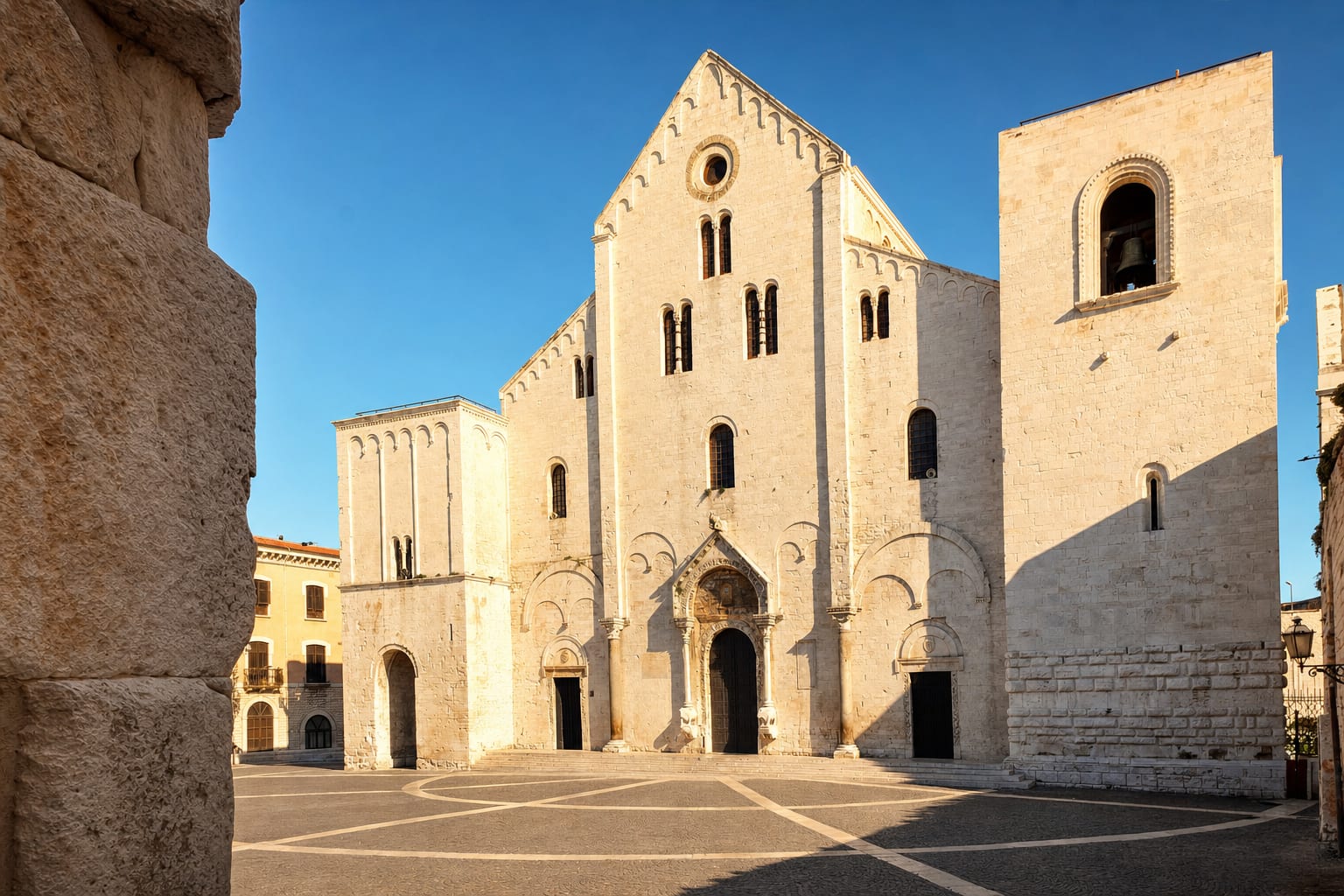 The white Romanesque facade of the Basilica di San Nicola, Bari