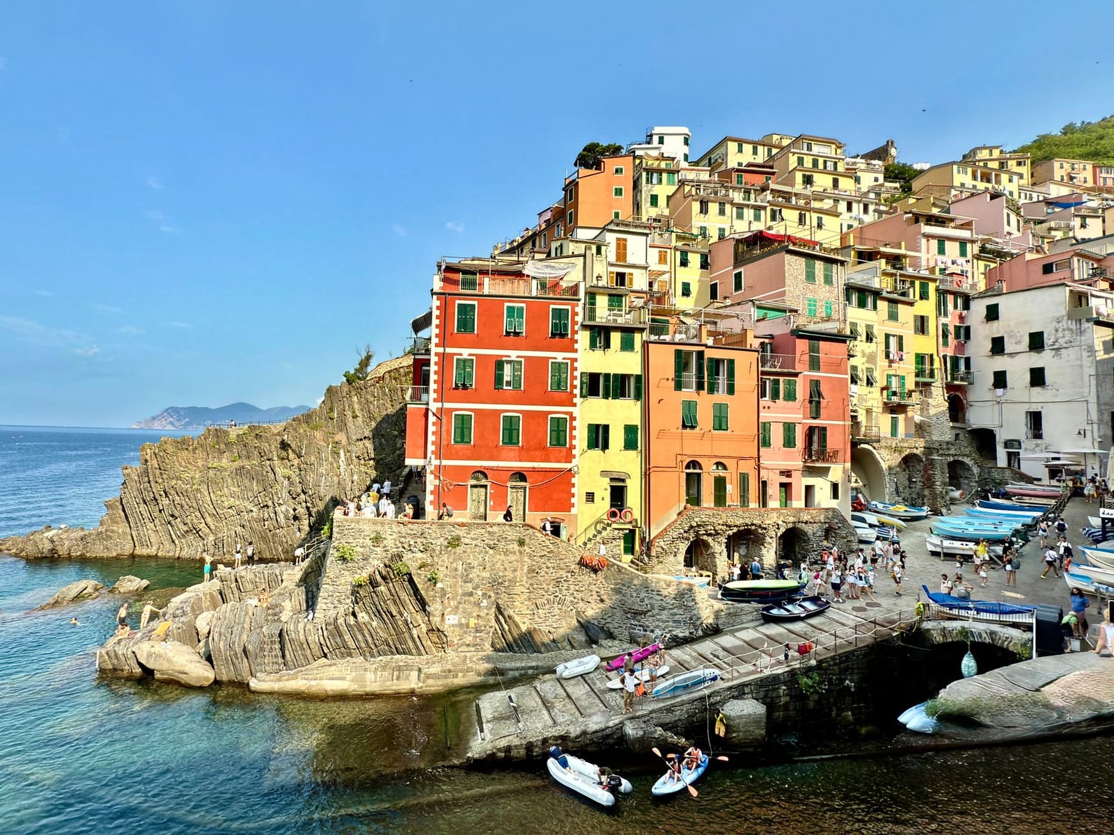 Riomaggiore's painted houses stacked above their Cinque Terre cove