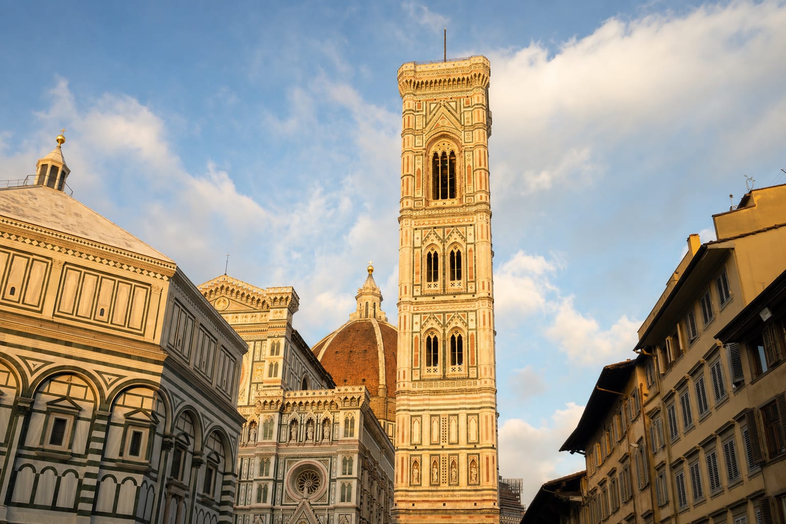 Giotto's marble campanile beside the Florence Baptistery at dusk