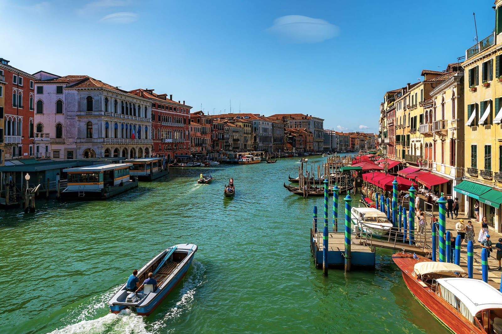 The Grand Canal's bend alive with boats between palace facades, Venice