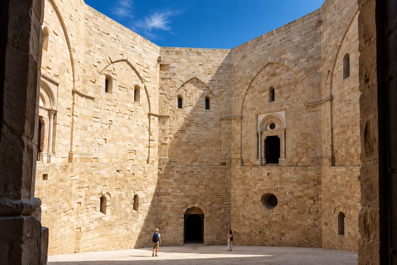 The eight-sided courtyard of Castel del Monte with tall limestone walls