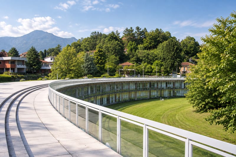 The curving Olivetti Western Residential Unit seen from its white walkway