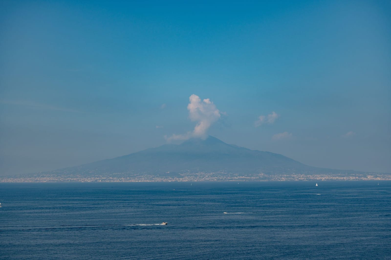 Vesuvius across the Bay of Naples, its summit in cloud