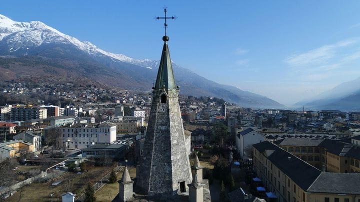 Aosta's steeple against the snowbound Alps