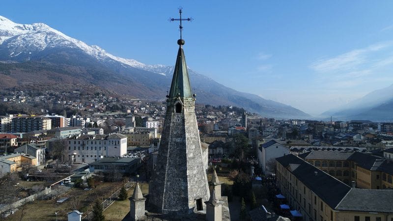 Aosta's steeple against the snowbound Alps