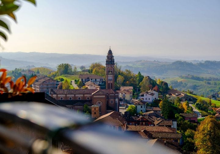 Barolo's bell tower amid the vineyards of the Langhe