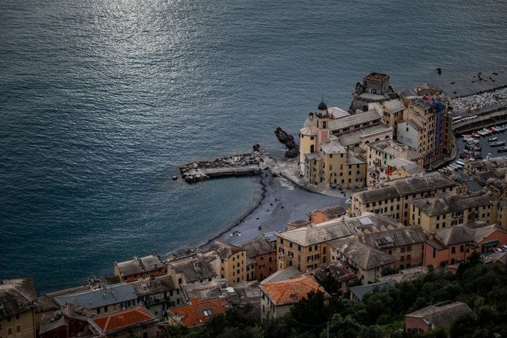 The Castello della Dragonara guarding Camogli's harbor at dusk
