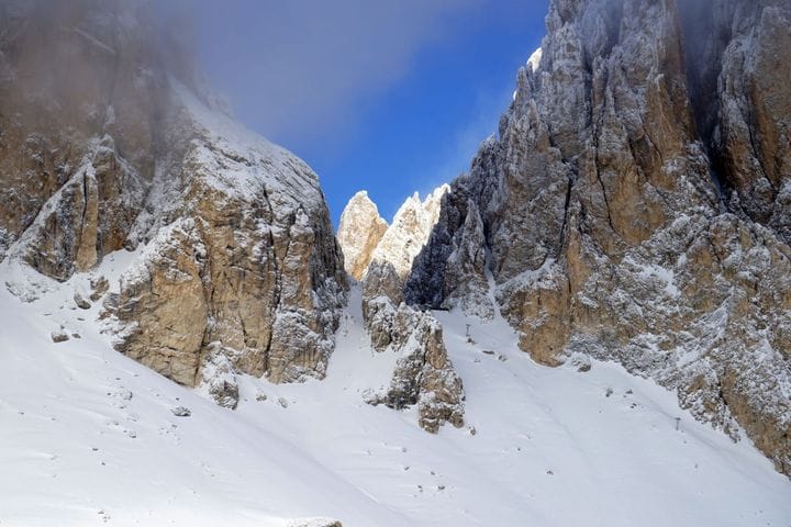 Dolomite spires in snow above the Val di Fassa near Canazei