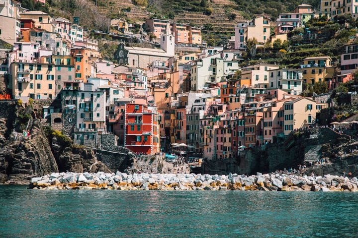 Riomaggiore's houses stacked above its harbor cleft