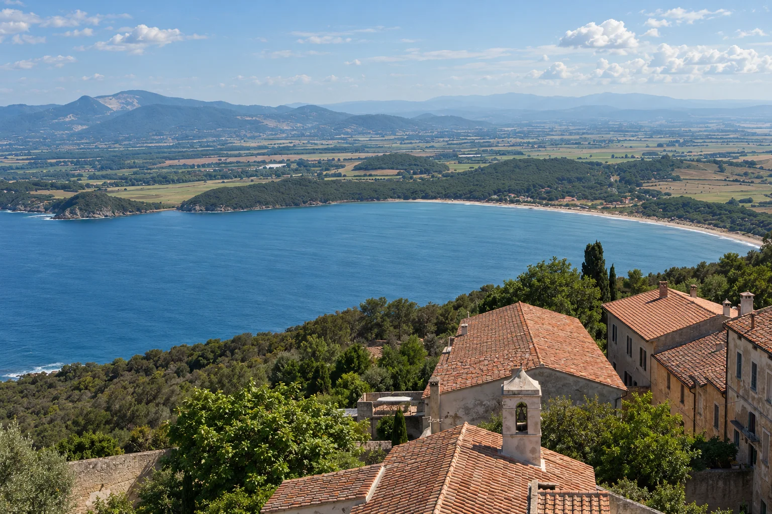 The Gulf of Baratti and coastal hills seen above Populonia’s terracotta rooftops
