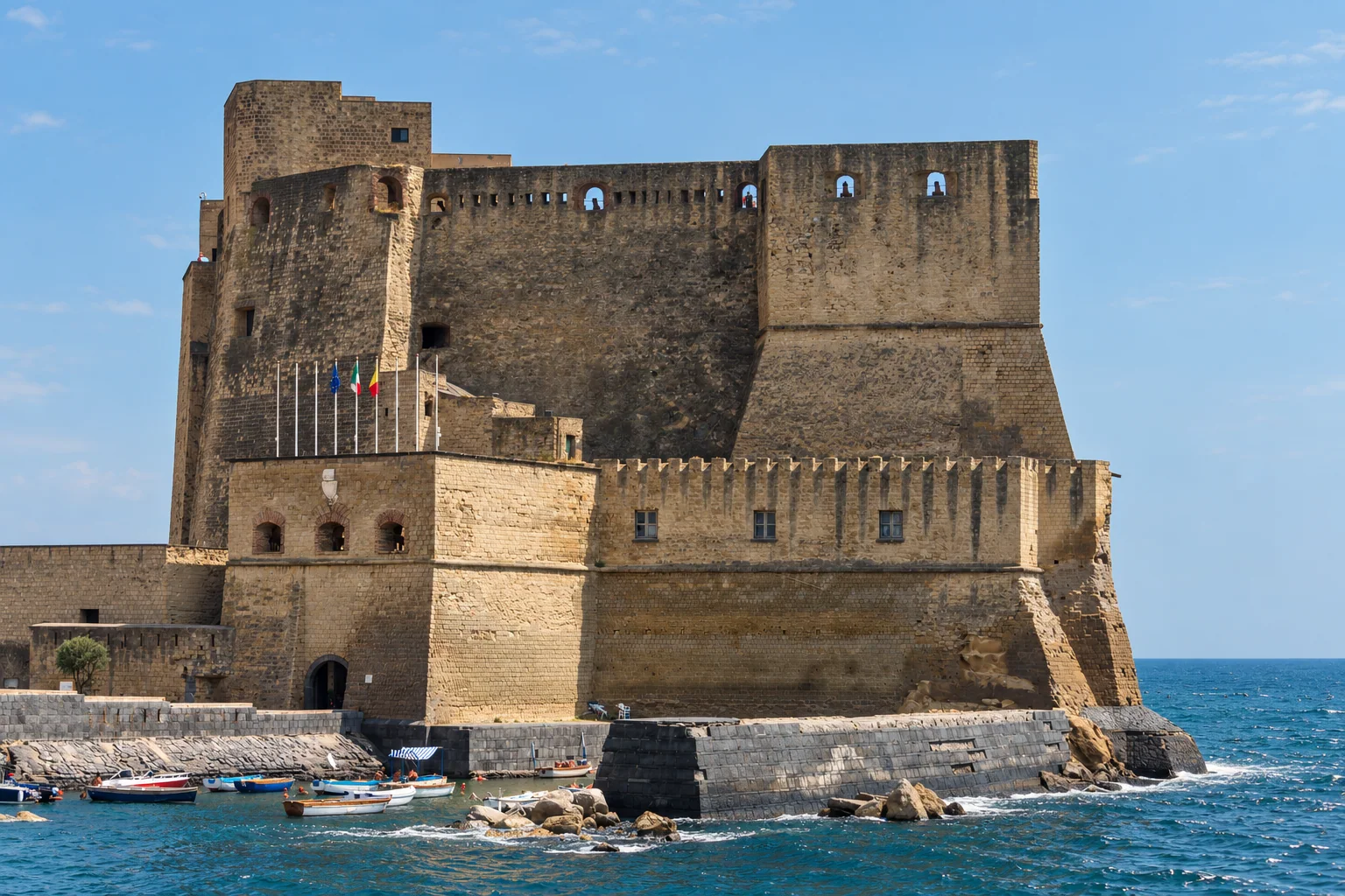 Castel dell’Ovo’s layered walls rise directly above the rocky edge of Megaride.