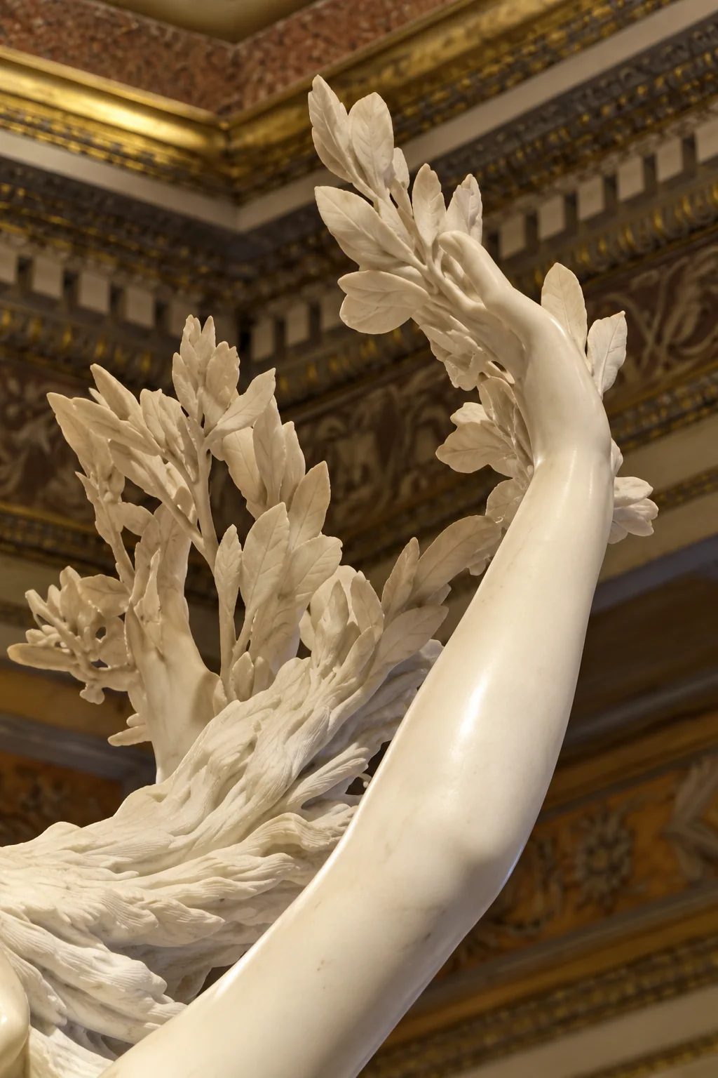 Carved marble hand and laurel leaves at the top of Bernini’s Apollo and Daphne