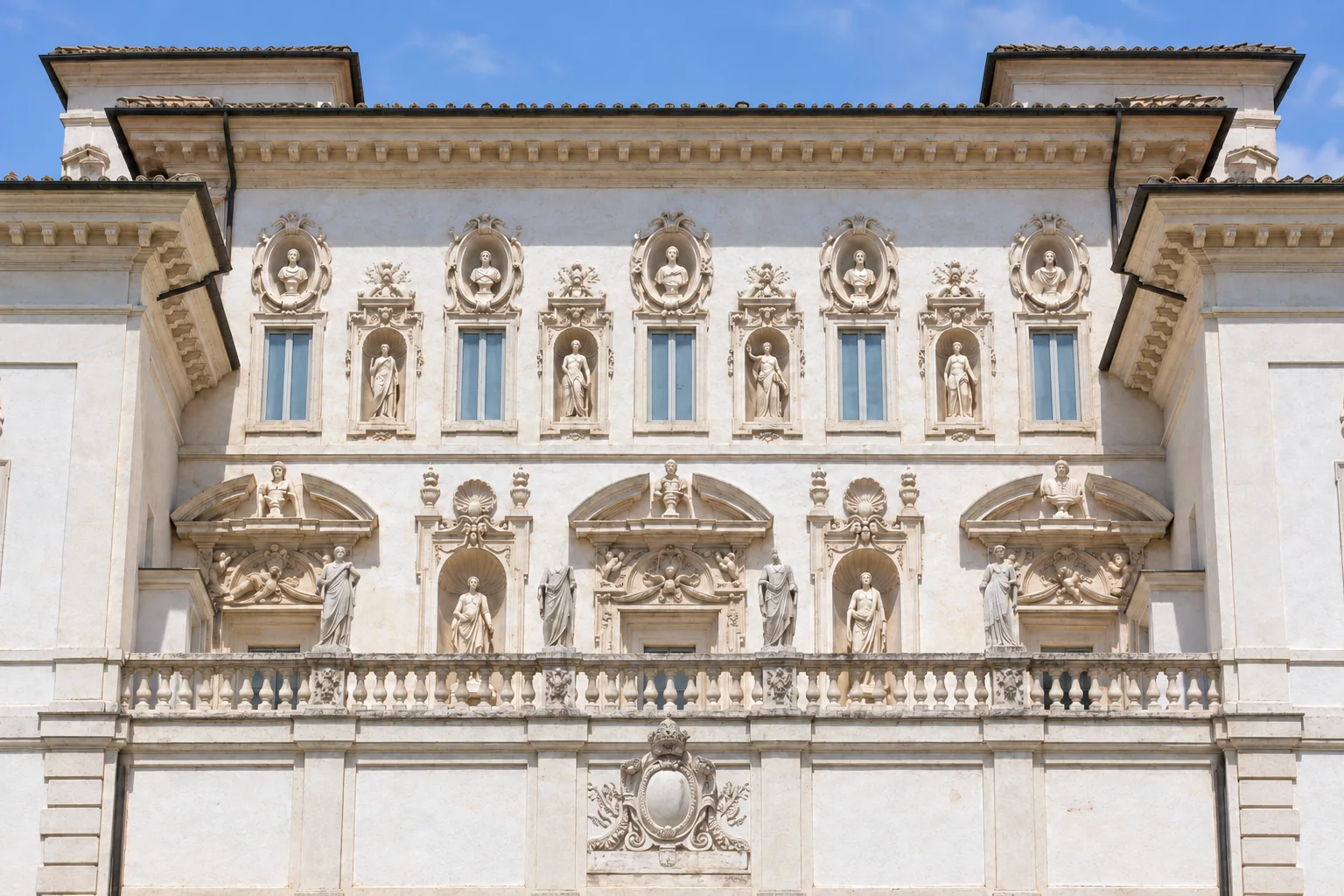 Upper façade of Villa Borghese Pinciana with five windows, four statue niches and oval portrait medallions