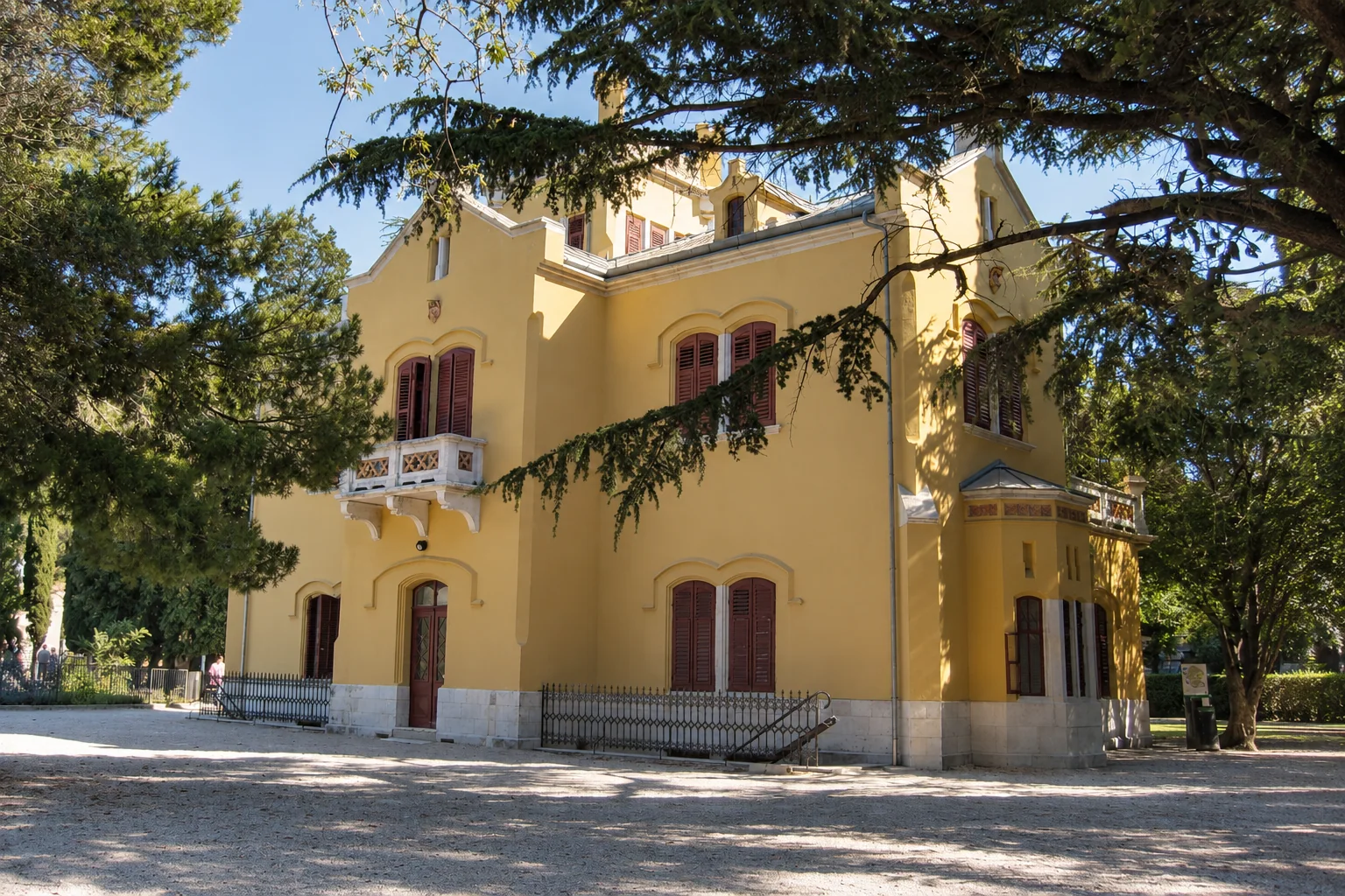 The yellow Castelletto is a separate building within Miramare’s wooded park.