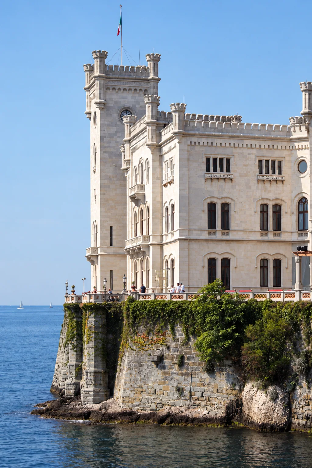 The tower and adjoining rooms rise above Miramare’s stone seawall.