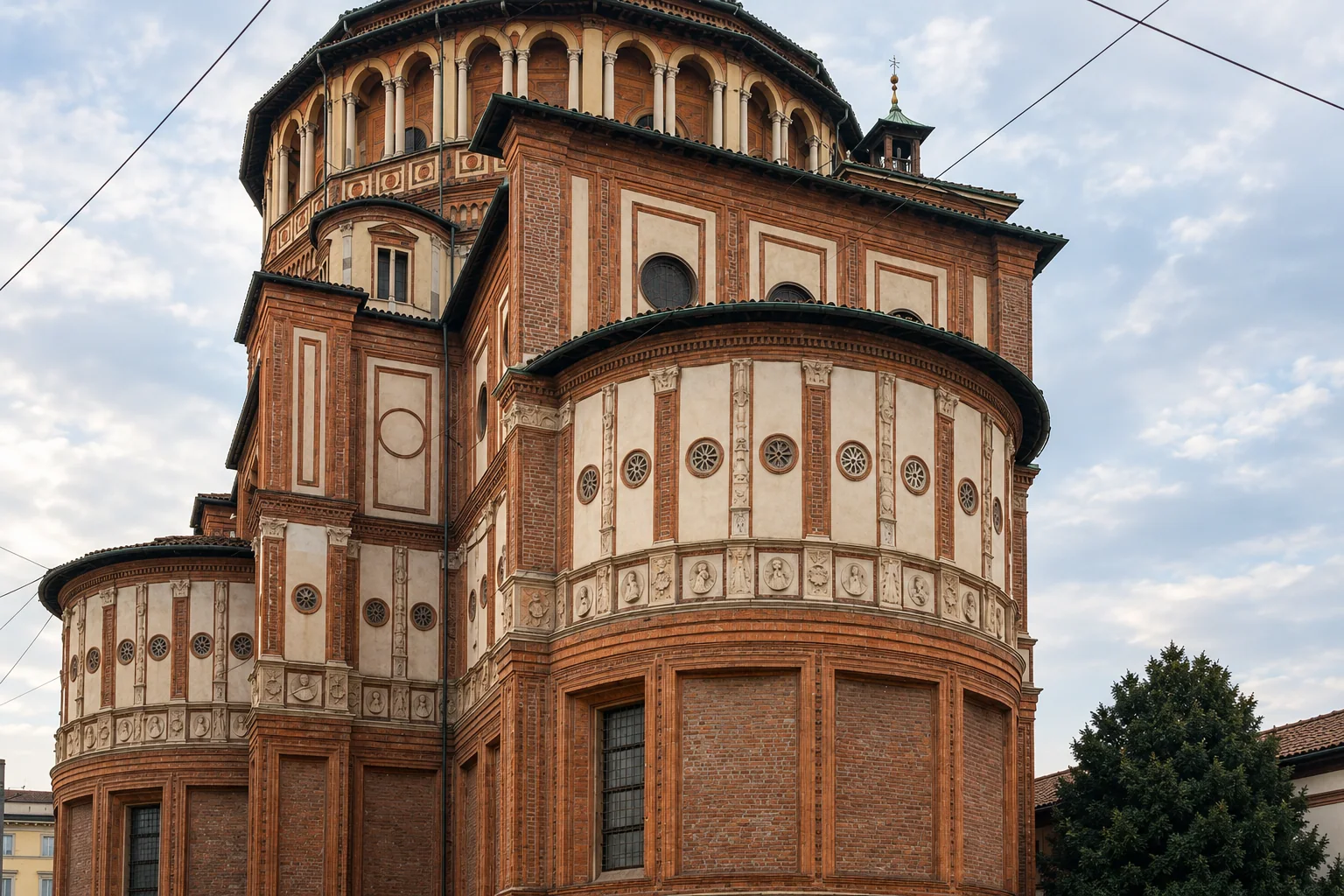 Curved terracotta apse and upper arcaded tribune of Santa Maria delle Grazie beside the street