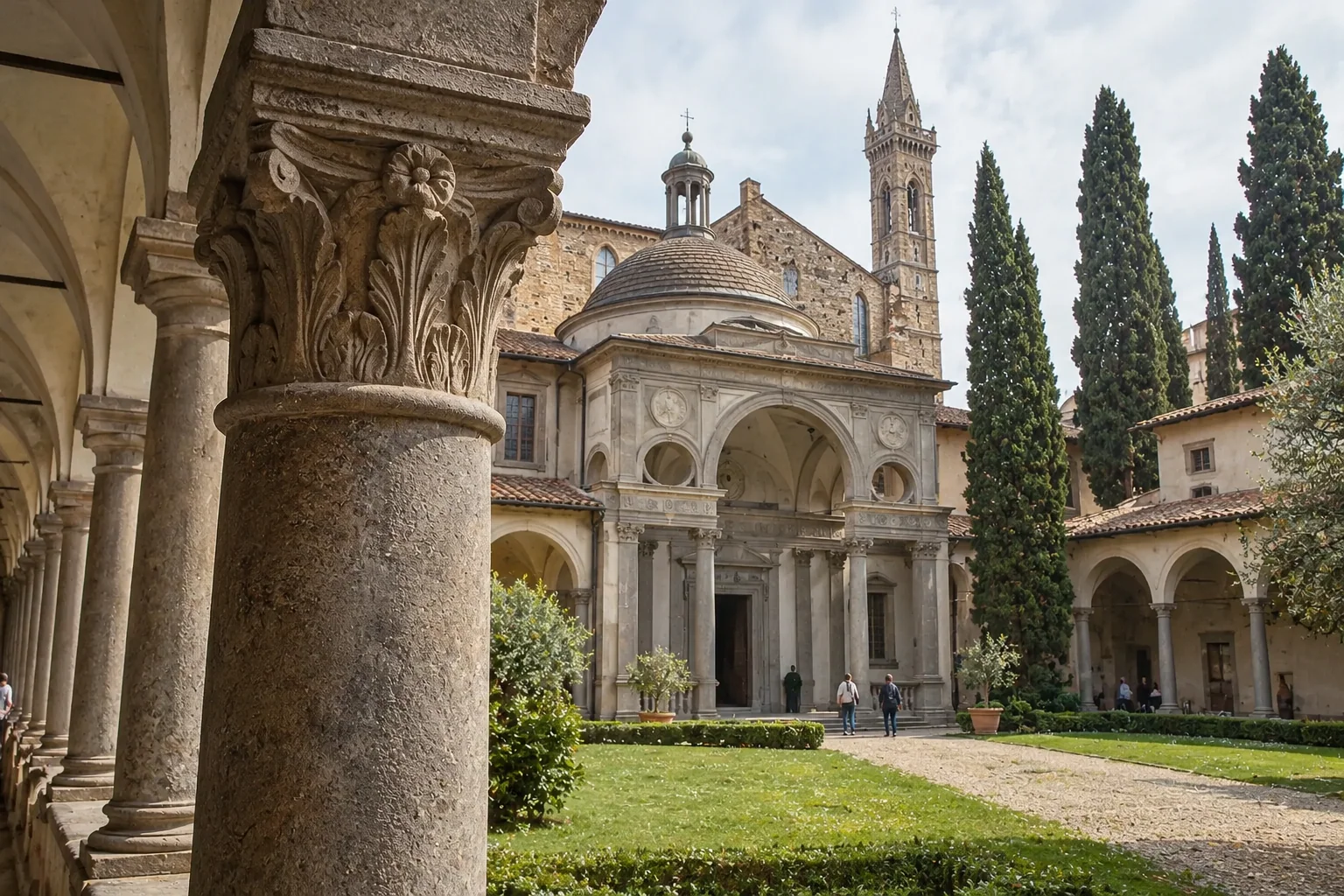 The Pazzi Chapel at the end of the first cloister, framed by arcades, cypress trees and a green lawn
