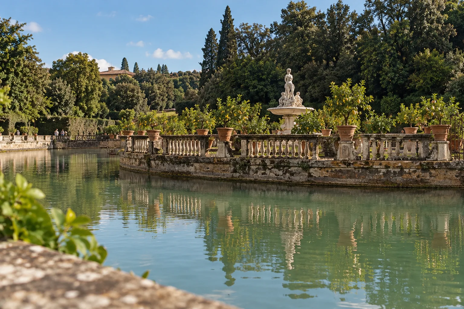 The Isolotto island with lemon pots and a fountain, reflected in the pond
