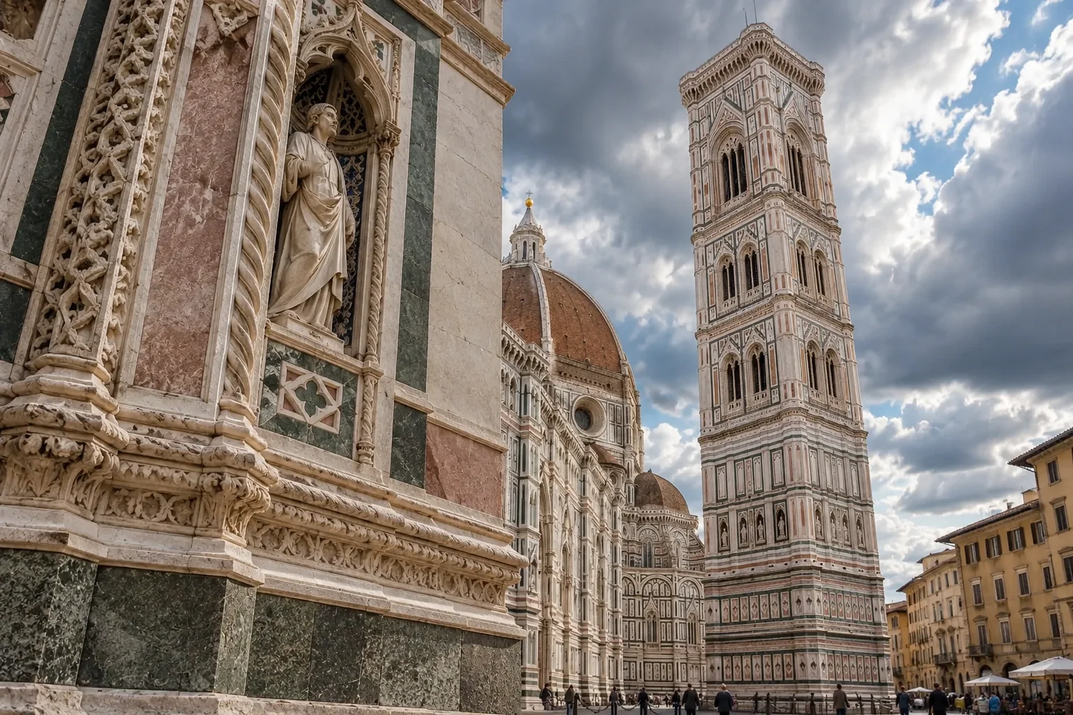 Looking steeply up the marble face of Giotto’s Campanile, with statues in niches and dramatic clouds