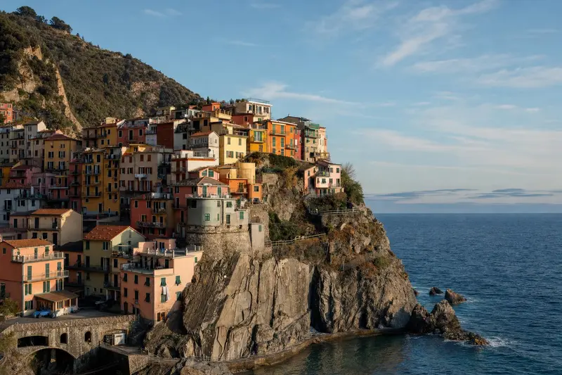 The pastel houses of Manarola above its rocky harbour