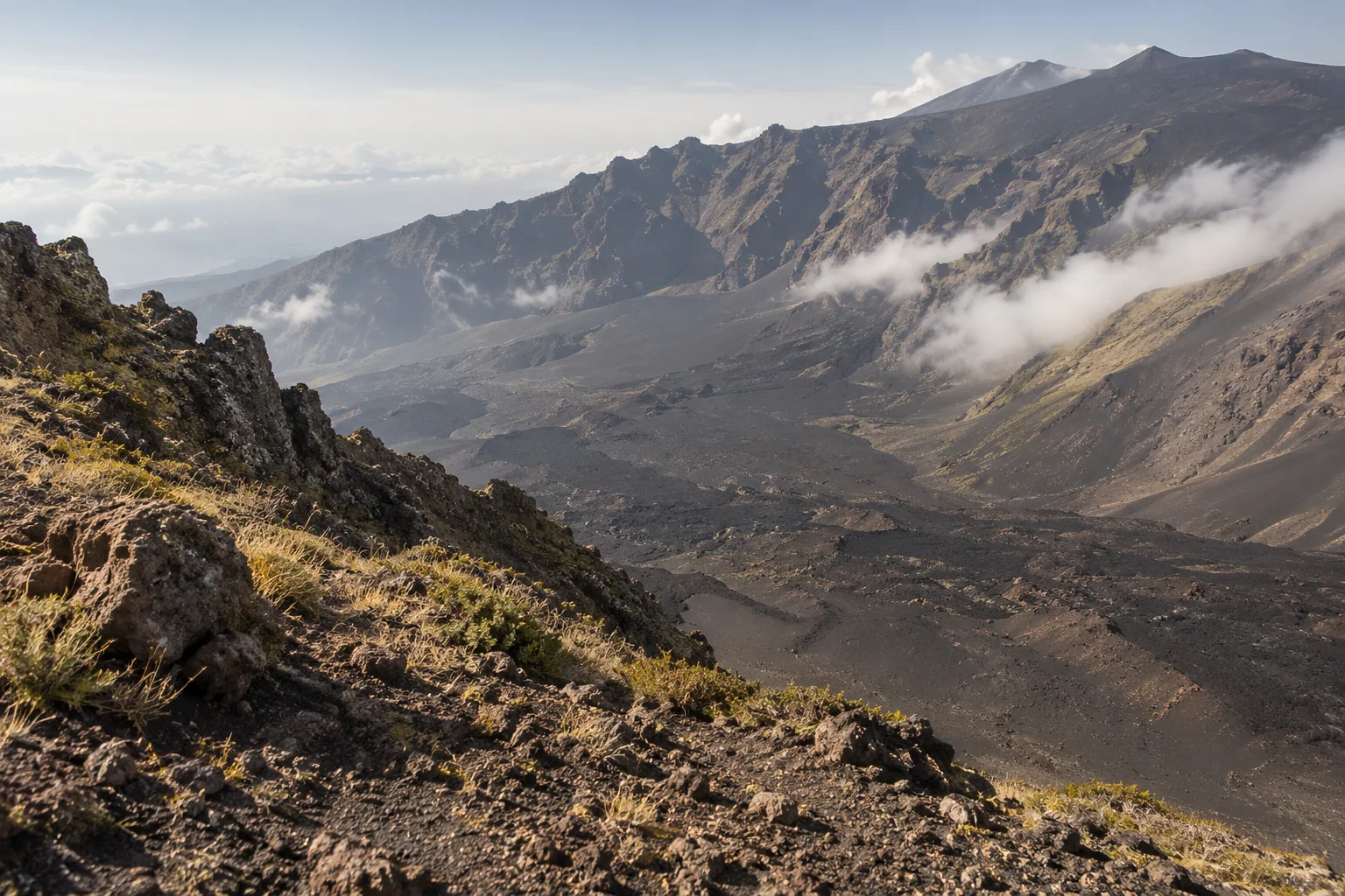 The steep-walled Valle del Bove with lava streaks and drifting cloud