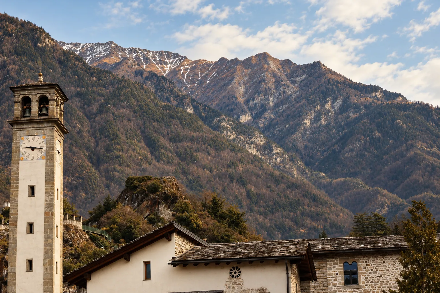 A stone bell tower beneath the peaks at Chiavenna