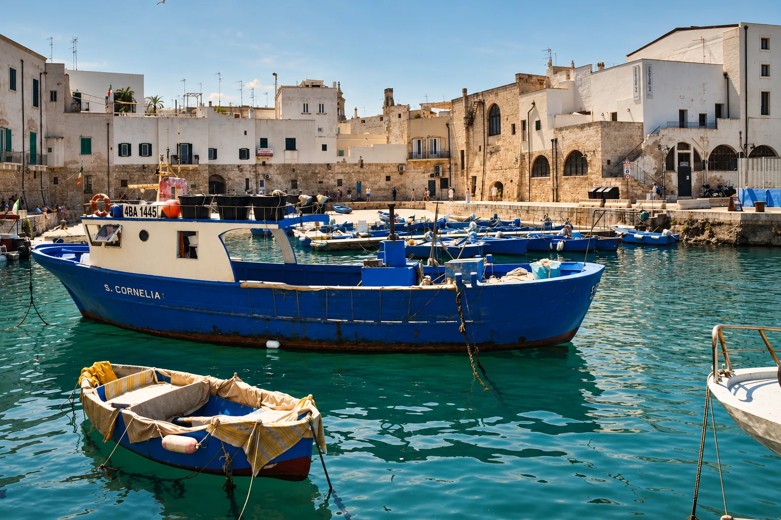 Blue gozzi moored in Monopoli's old port