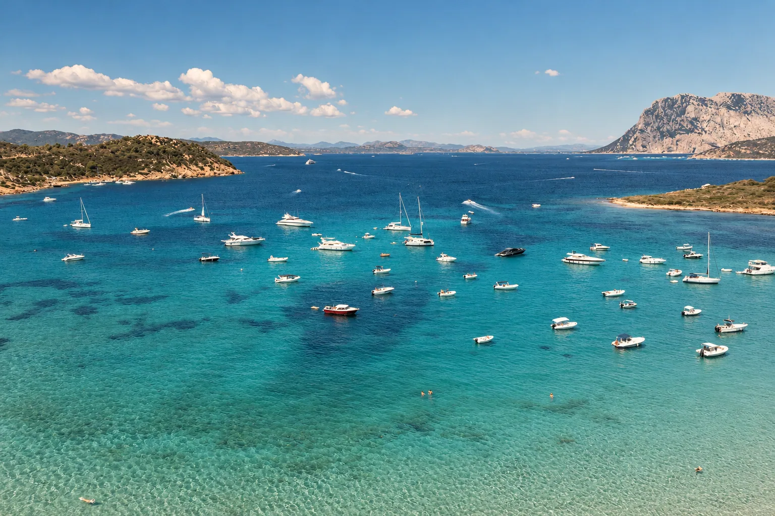 Boats at anchor off San Teodoro beneath Tavolara