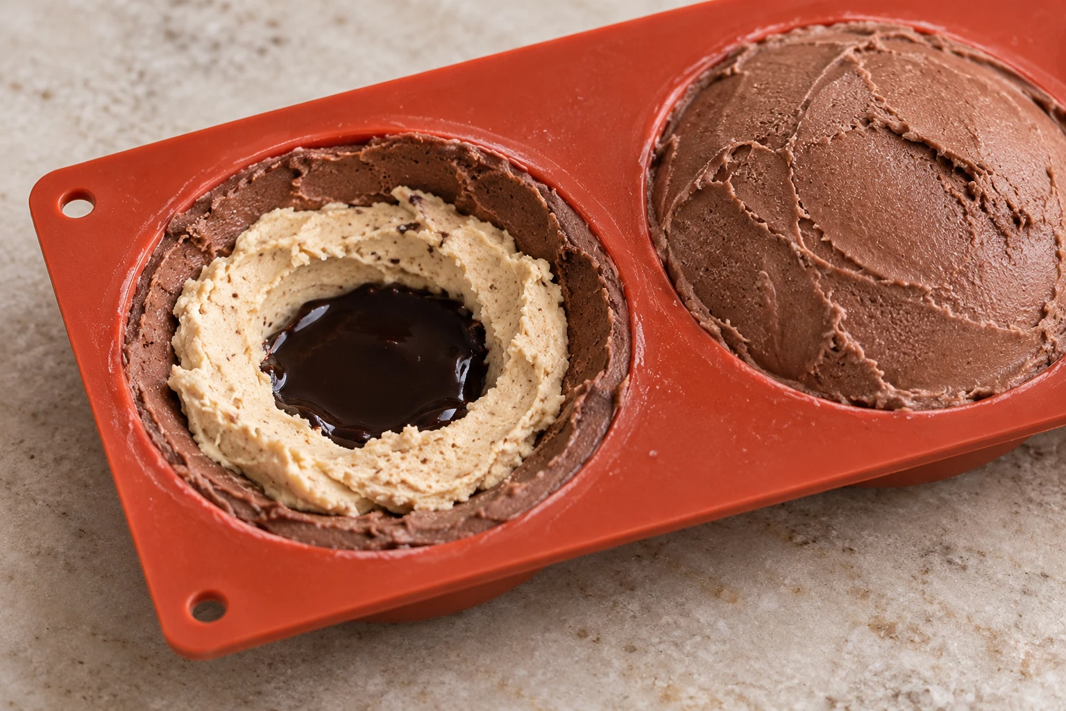 A mould with chocolate and hazelnut gelato surrounding a dark cocoa centre.